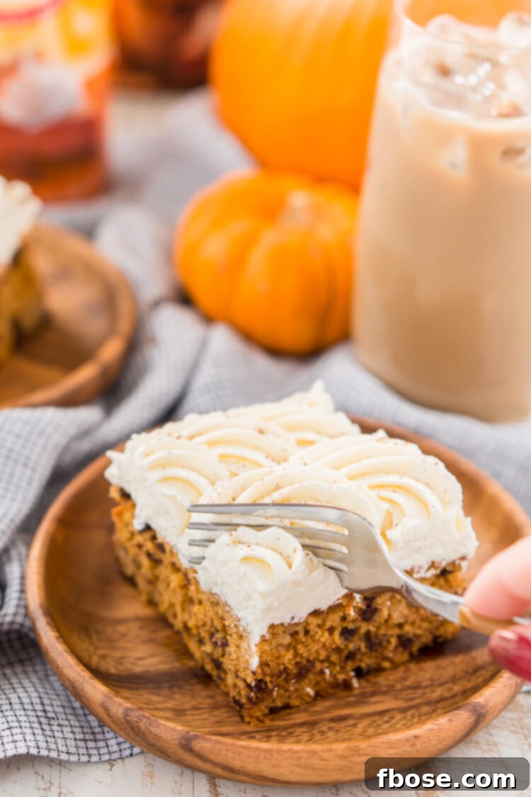 Close-up of the moist Pumpkin Chocolate Chip Poke Cake with frosting