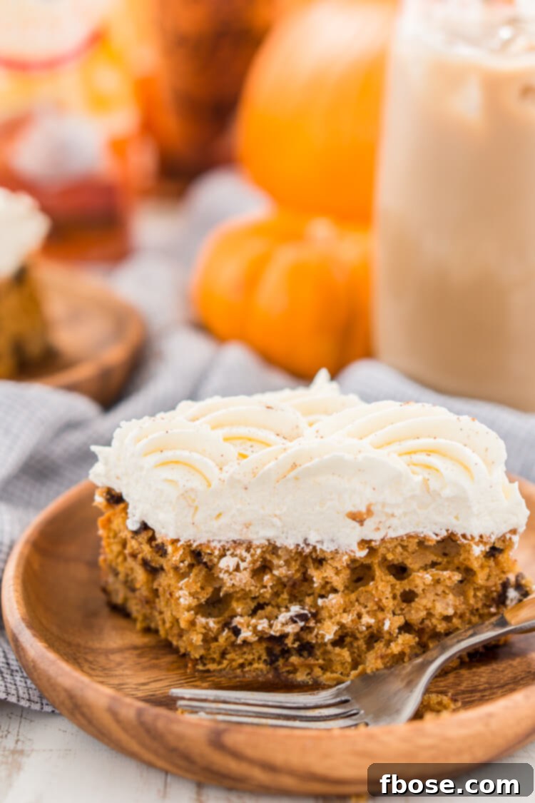 Delicious Pumpkin Chocolate Chip Poke Cake with frosting and chocolate chips