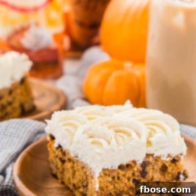Delicious Pumpkin Chocolate Chip Poke Cake with creamy cheesecake frosting