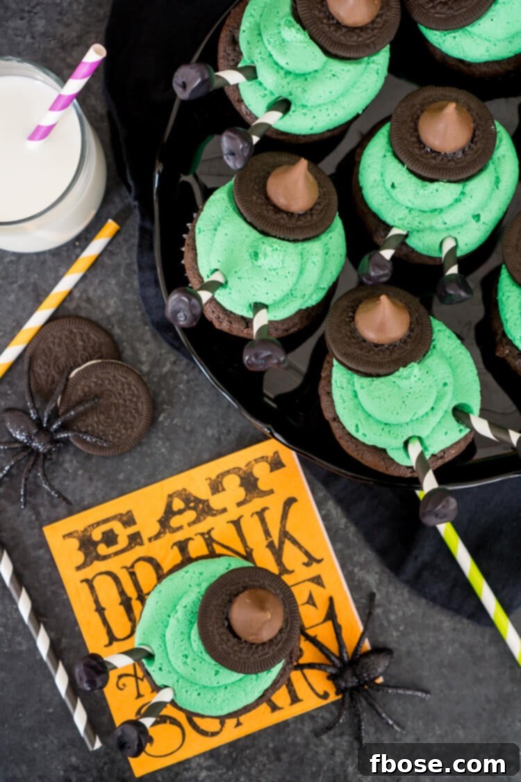 Close-up of Melted Witch Cupcakes, showcasing the green frosting, Oreo witch hat, and striped straw legs.