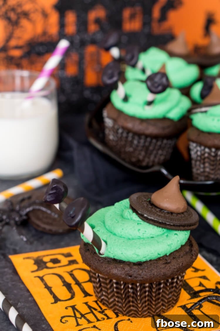 Melted Witch Cupcakes arranged on a festive Halloween plate with other decorations.