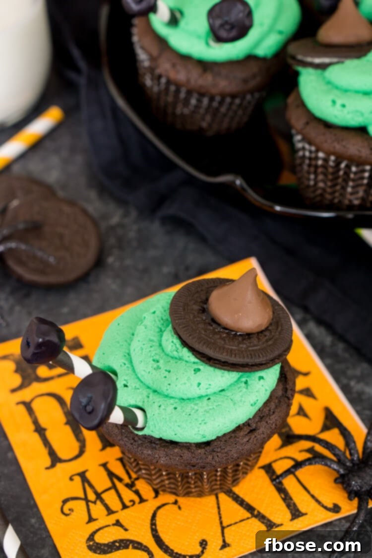 Close-up of Melted Witch Cupcakes with vibrant green frosting and witch hat decorations.