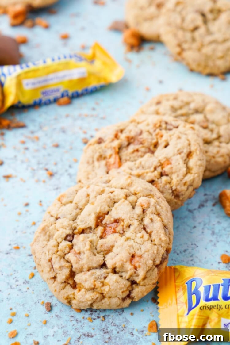 Decadent Butterfinger Pudding Cookies 4 A stack of golden brown Butterfinger pudding cookies, highlighting their soft texture and candy inclusions.
