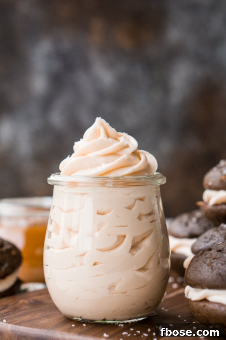 Rich Salted Caramel Frosting generously spread on cupcakes, promising a delightful sweet and salty experience.