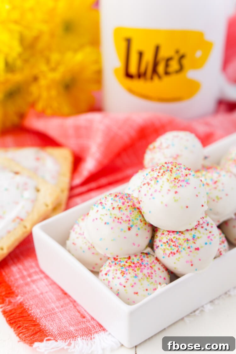 A plate full of pink and white Gilmore Girls Pop Tart Truffles with rainbow sprinkles.