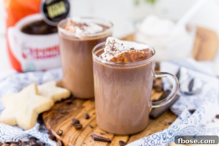 A close-up of Hot Chocolate Coffee being garnished with chocolate shavings.