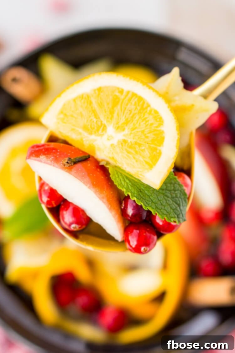 Crock Pot Potpourri simmering with holiday scents of cinnamon, orange, and cranberries.