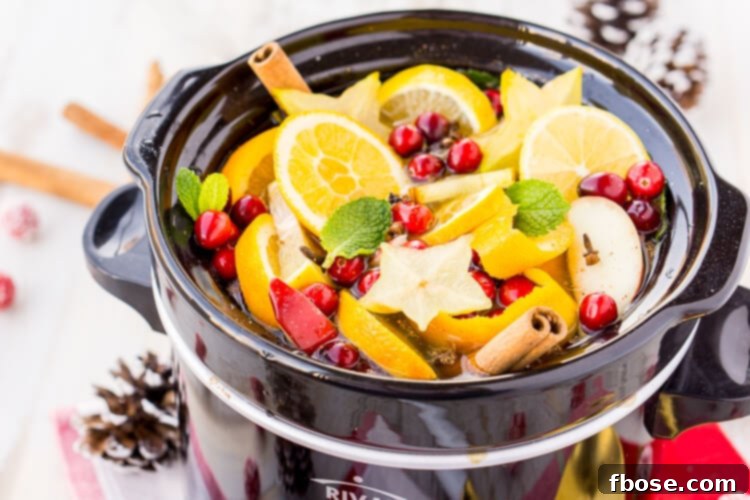 A beautifully composed shot of DIY Holiday Crock Pot Potpourri ingredients, ready to simmer and fill the home with festive cheer.