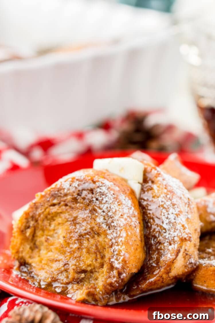 A warm, inviting image of Gingerbread French Toast Bake Casserole, dusted with powdered sugar and drizzled with maple syrup, perfect for a snowy holiday morning.