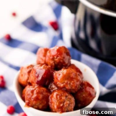 Cranberry Orange Meatballs in a slow cooker, a perfect party appetizer. Featuring tender meatballs coated in a sweet and tangy sauce.