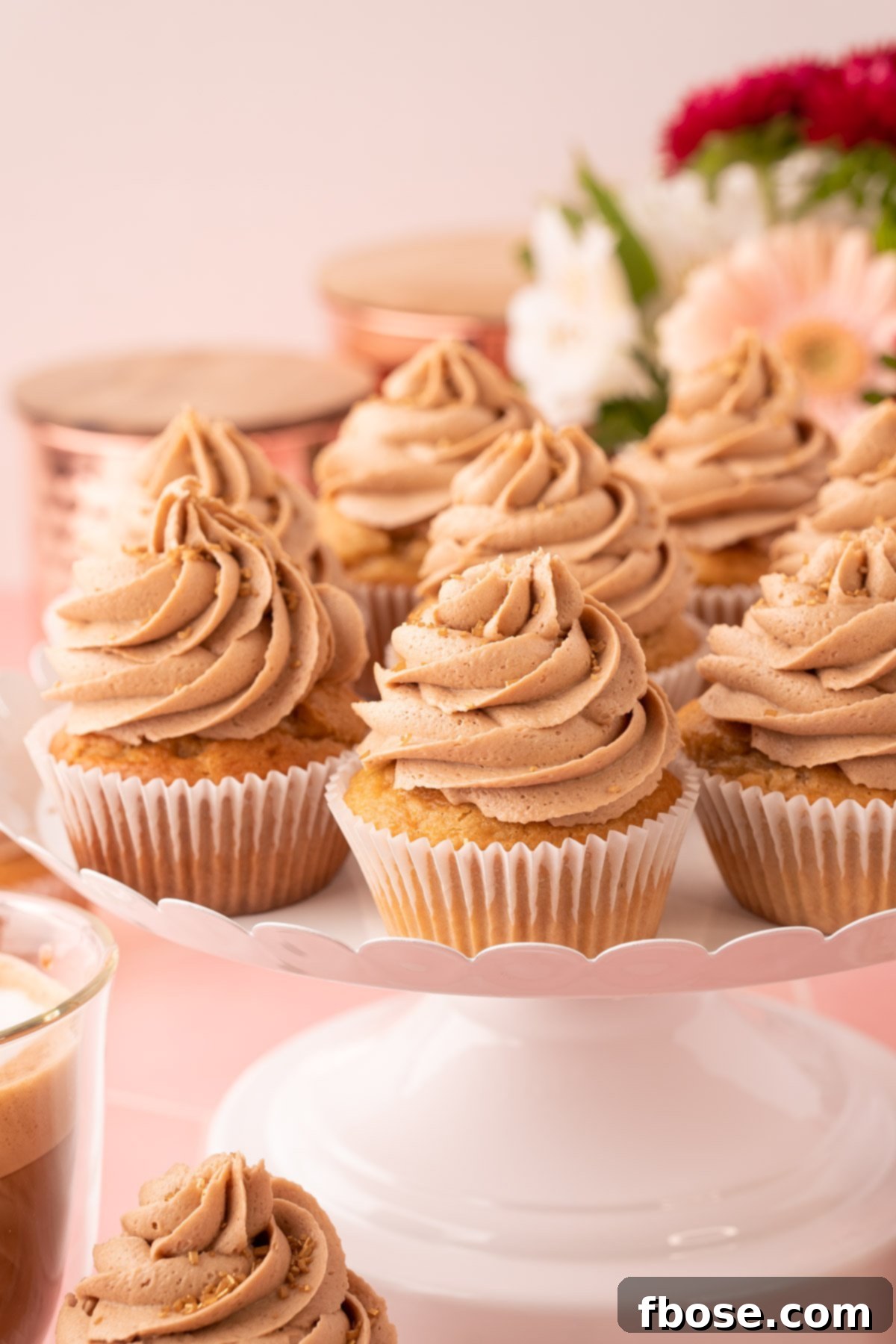 French Vanilla Cappuccino Cupcakes on a white cake stand.