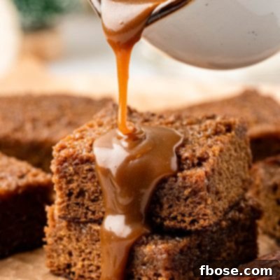 Toffee sauce being poured over sticky toffee pudding.