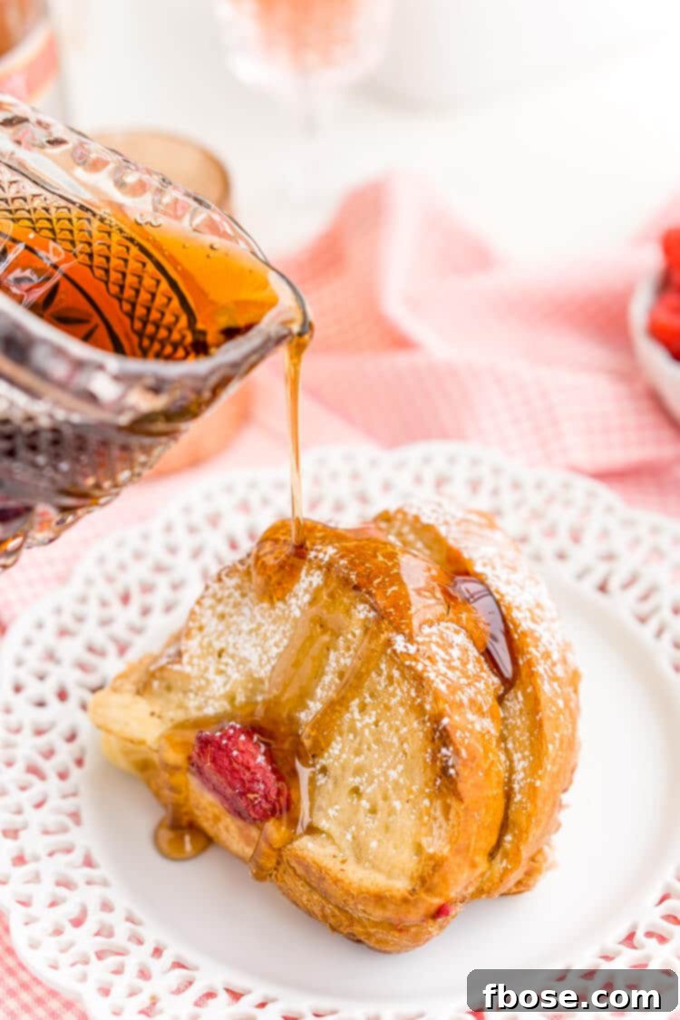 Champagne Raspberry Baked French Toast, a delightful make-ahead breakfast casserole, perfect for New Year's, Valentine's Day, or any special celebration. Top with fresh berries and maple syrup.