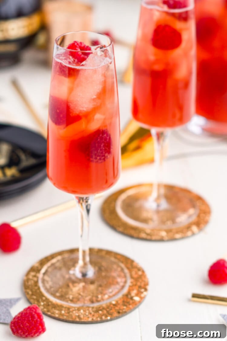 New Year's Eve Champagne Punch made Triple Sec, blackberry brandy, Chambord, pineapple juice, ginger ale, and champagne.