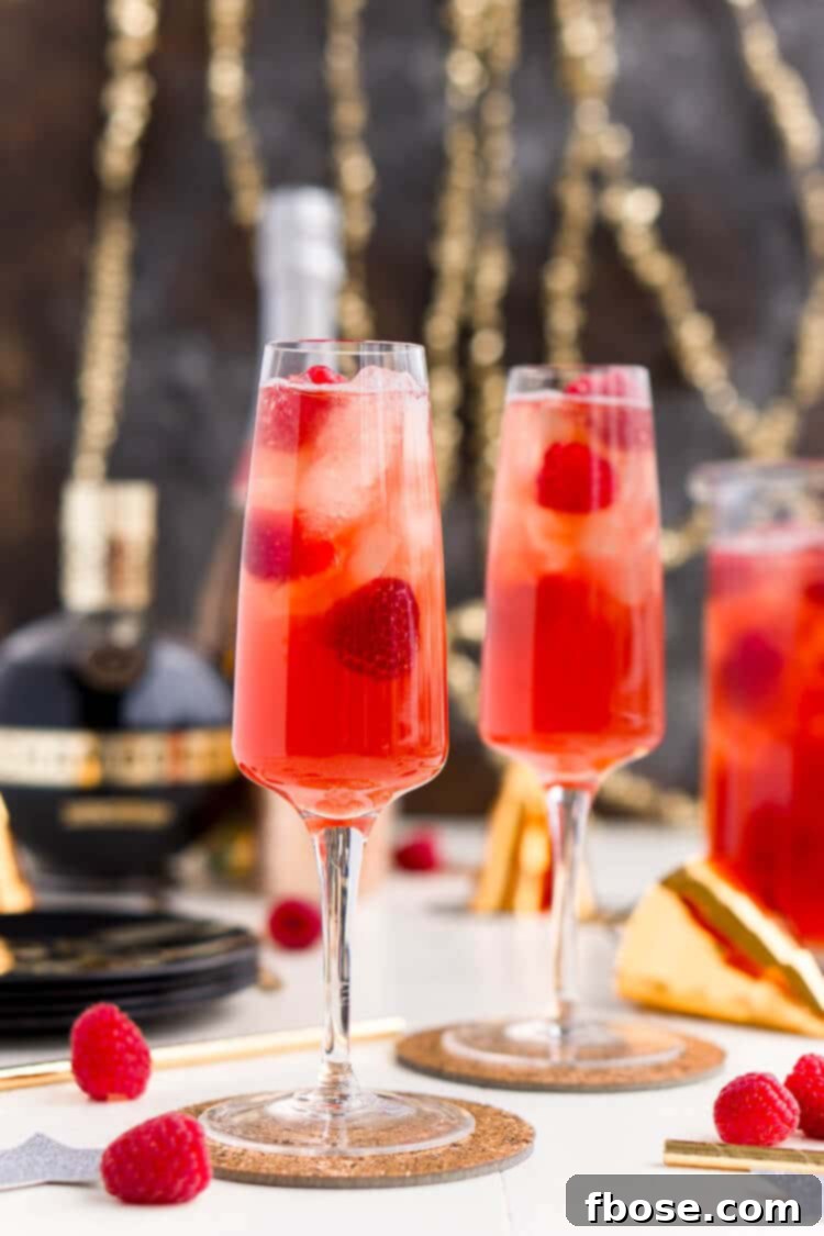 New Year's Eve Champagne Punch is loaded with Triple Sec, blackberry brandy, Chambord, pineapple juice, ginger ale, and champagne for a drink that's sure to impress all your NYE party guests!