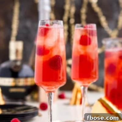 New Year's Eve Champagne Punch is loaded with Triple Sec, blackberry brandy, Chambord, pineapple juice, ginger ale, and champagne for a drink that's sure to impress all your NYE party guests!