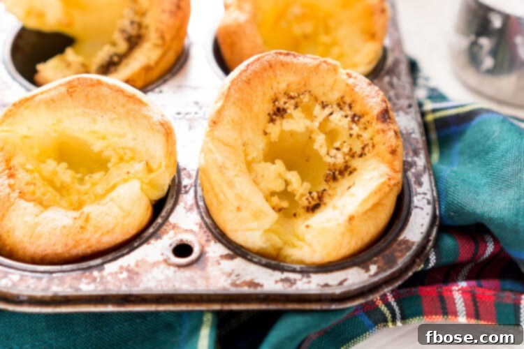 Close-up of perfectly risen Yorkshire Puddings in a muffin tin