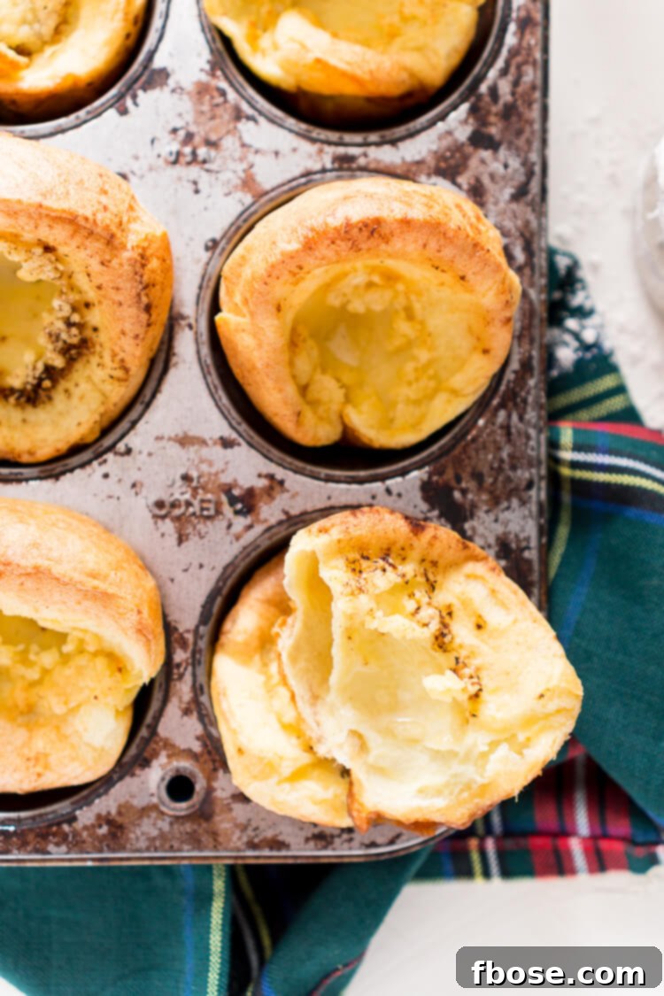 A plate of golden, airy Yorkshire Puddings with a delicious crust