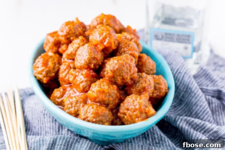 A bowl of Pineapple Tequila Meatballs, garnished with fresh herbs, ready for serving.