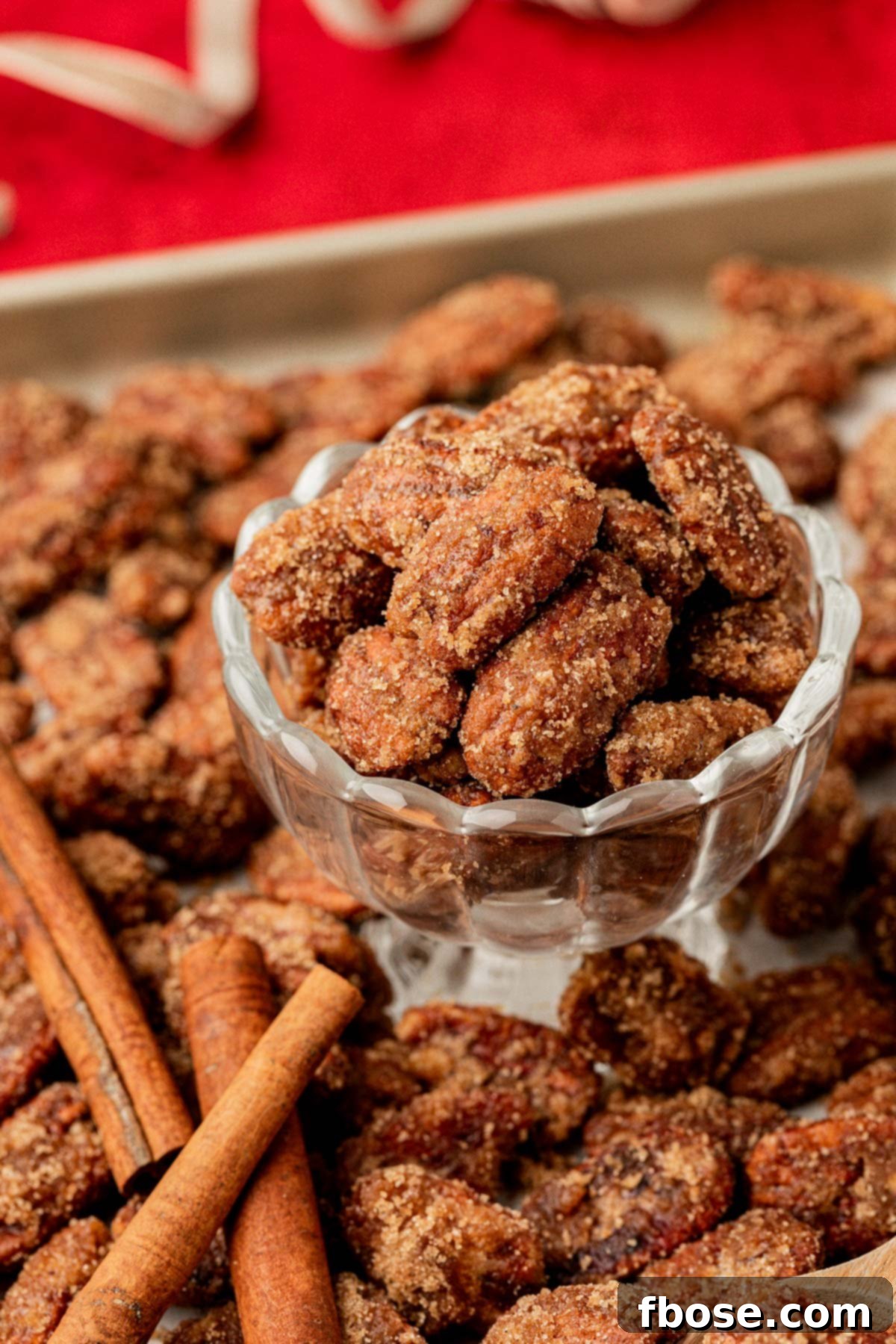 A bowl of freshly made candied pecans, perfectly glazed and ready to eat.