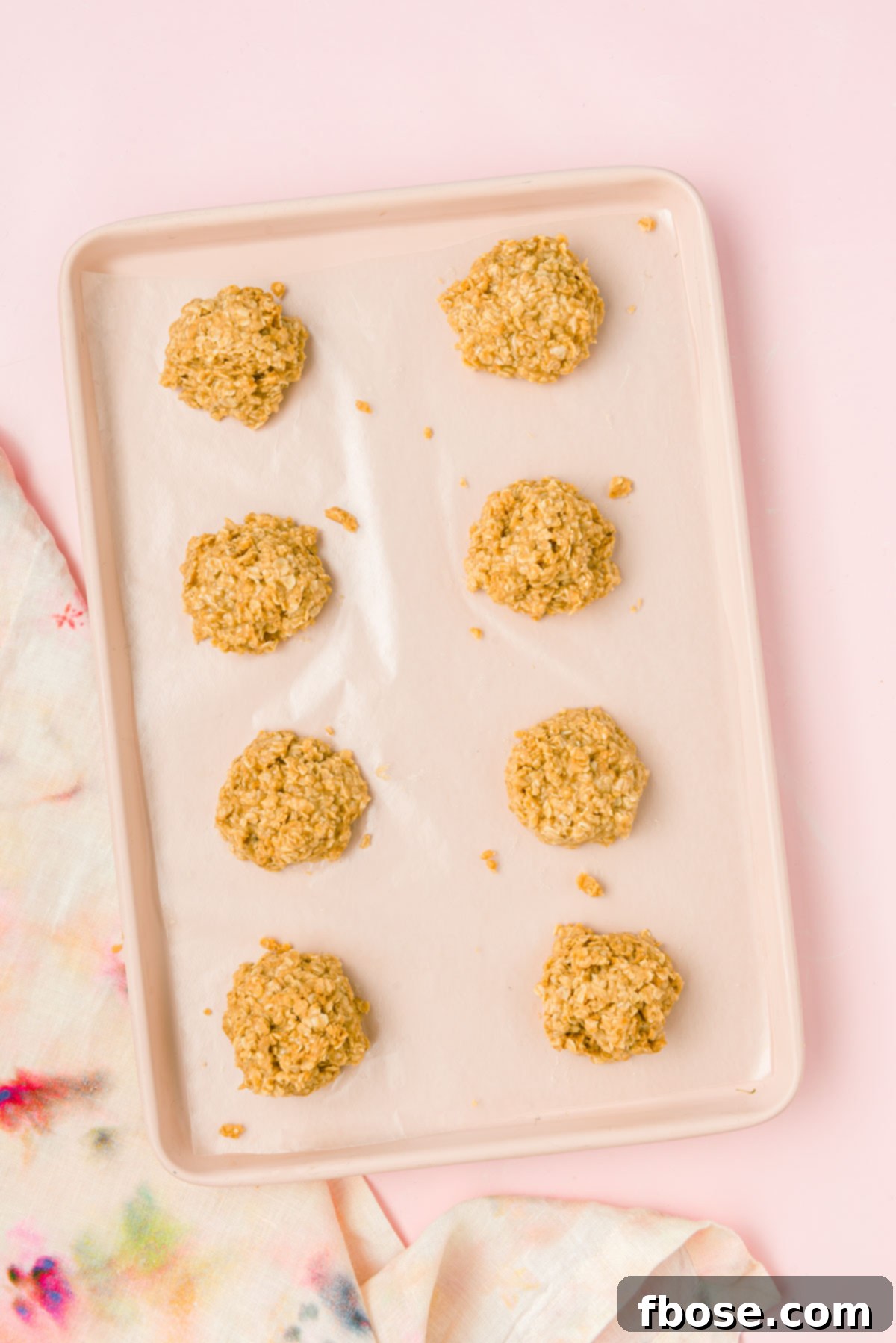 Perfectly formed cookie butter no bake cookies are cooling on a wax paper-lined baking sheet, firming up to their ideal consistency.