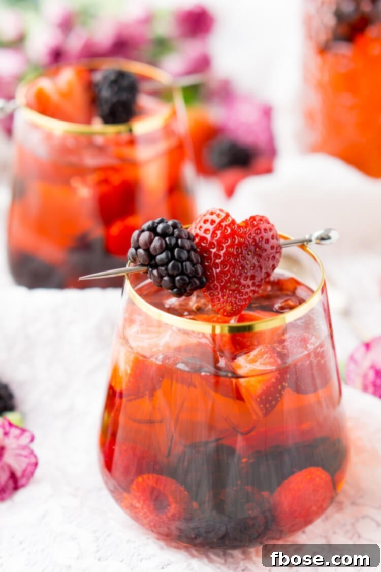 Rosé Berry Sangria is the perfect batch cocktail for Valentine's Day, Bridal Showers, and more! Made with rosé wine, Chambord, blackberry brandy, lemon-lime soda, and fresh berries!
