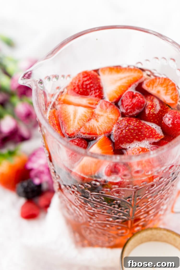 Rosé Berry Sangria is the perfect batch cocktail for Valentine's Day, Bridal Showers, and more! Made with rosé wine, Chambord, blackberry brandy, lemon-lime soda, and fresh berries!