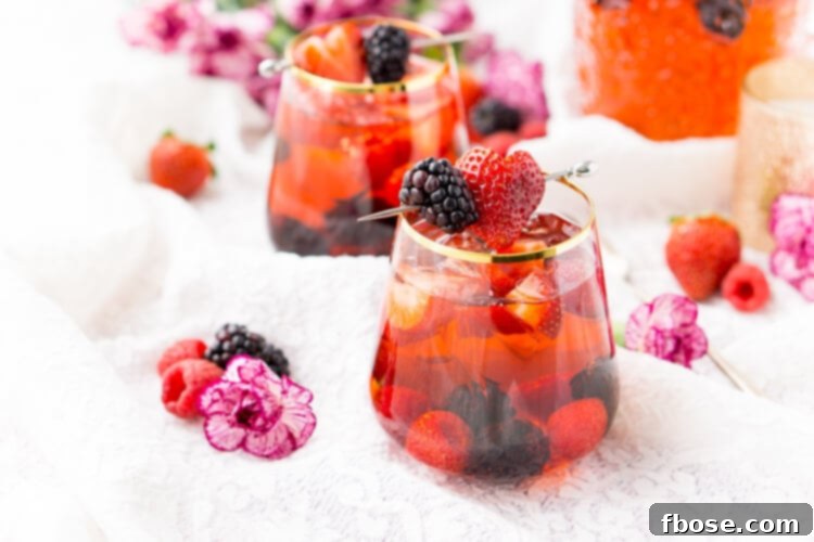 Rosé Berry Sangria is the perfect batch cocktail for Valentine's Day, Bridal Showers, and more! Made with rosé wine, Chambord, blackberry brandy, lemon-lime soda, and fresh berries!