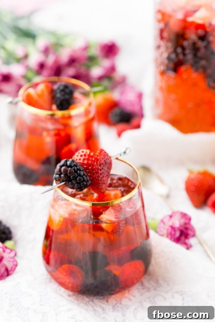 Rosé Berry Sangria is the perfect batch cocktail for Valentine's Day, Bridal Showers, and more! Made with rosé wine, Chambord, blackberry brandy, lemon-lime soda, and fresh berries!