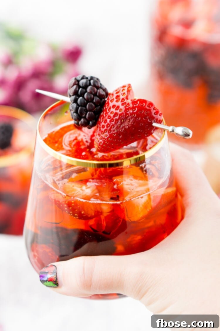 Rosé Berry Sangria is the perfect batch cocktail for Valentine's Day, Bridal Showers, and more! Made with rosé wine, Chambord, blackberry brandy, lemon-lime soda, and fresh berries!