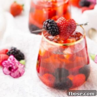 Glass of Rose Sangria garnished with blackberry and strawberry
