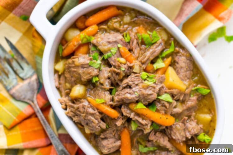 Close-up of tender Instant Pot Pot Roast with carrots, potatoes, and celery.