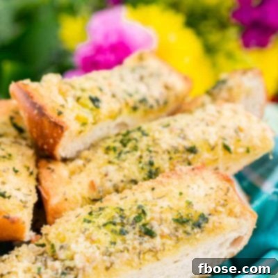 This Parmesan Garlic Bread is the perfect side for Bertolli's Frozen Chicken Florentine. A quick and easy recipe loaded with herbs, butter, and Parmesan cheese that can be whipped up in minutes!
