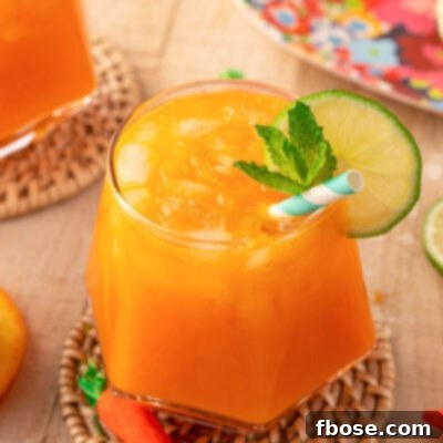 Close up of a glass or orange Easter punch on a rattan coaster.