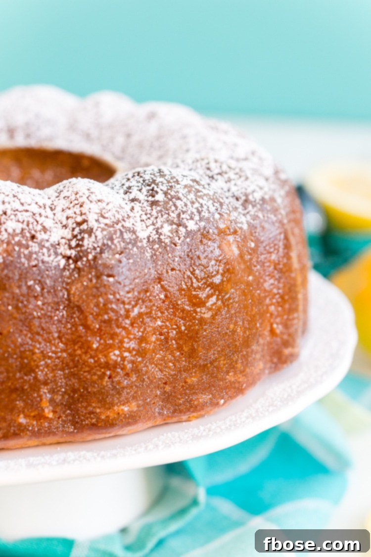 A perfectly baked Lemon Butter Cake, showcasing its dense texture and golden hue, ready for slicing.