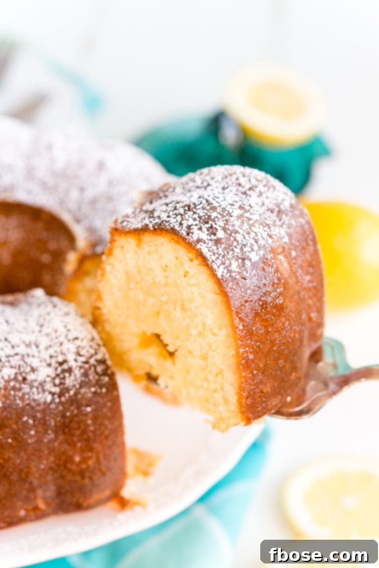 Close-up of a Lemon Butter Cake slice with a delicate lemon glaze, highlighting its moist interior.