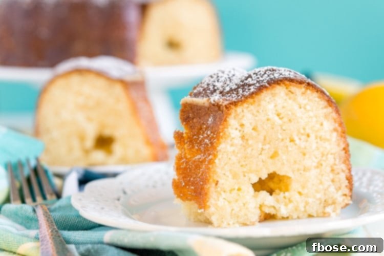 Lemon Butter Cake displayed on a stand, showcasing its inviting golden crust and elegant Bundt shape.