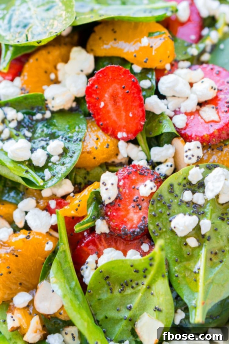 This Strawberry Spinach Salad will become your new go-to recipe for summer, it's made with simple, flavorful ingredients like goat cheese, almonds, poppyseeds, strawberries, mandarins, and spinach, and you can make it family or party-sized!
