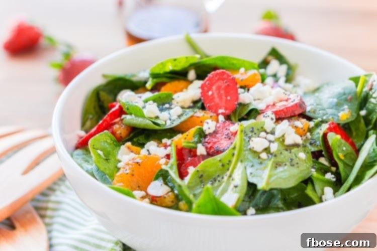 This Strawberry Spinach Salad will become your new go-to recipe for summer, it's made with simple, flavorful ingredients like goat cheese, almonds, poppyseeds, strawberries, mandarins, and spinach, and you can make it family or party-sized!