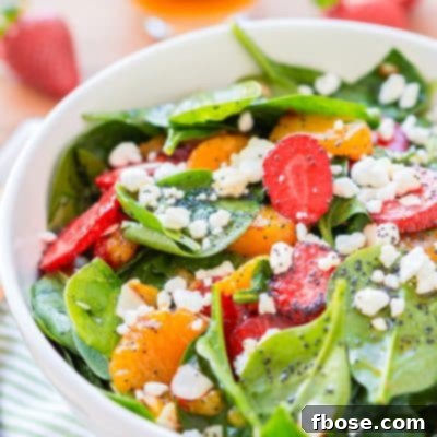 This Strawberry Spinach Salad will become your new go-to recipe for summer, it's made with simple, flavorful ingredients like goat cheese, almonds, poppyseeds, strawberries, mandarins, and spinach, and you can make it family or party-sized!