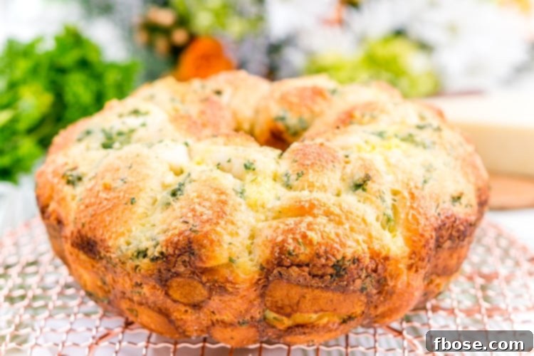 Close-up of fluffy Garlic Parmesan Monkey Bread baked in a bundt pan, showcasing its golden crust and delicious cheese topping.