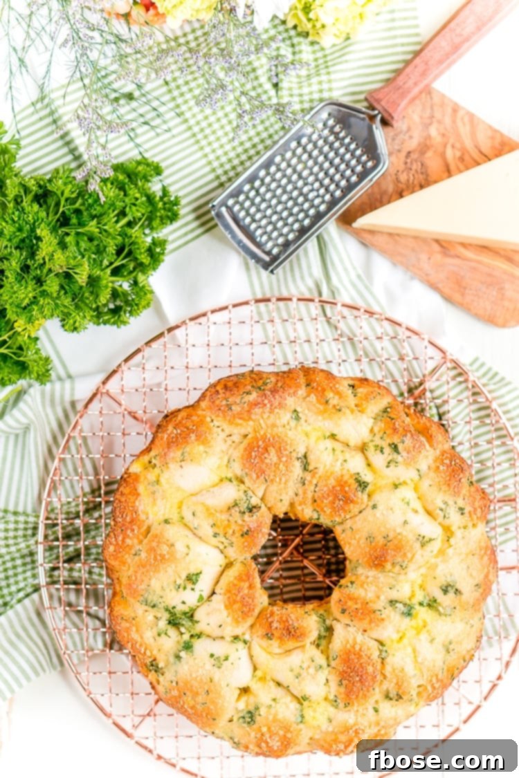 A serving of Garlic Parmesan Monkey Bread on a white platter, ready to be enjoyed as a savory side dish.