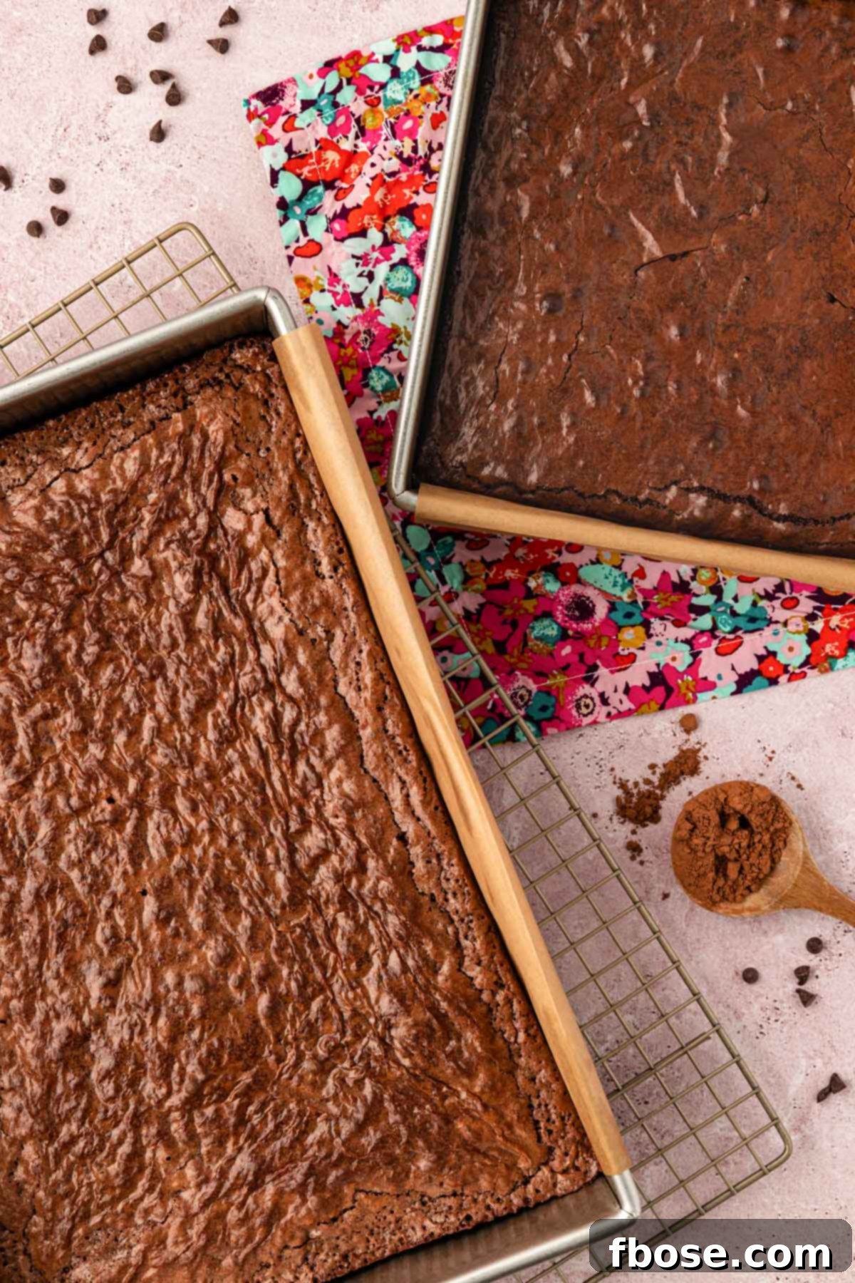 Overhead photo of two pans of brownies, one in a 9x13-inch pan and another in a 9x9-inch pan, showcasing different thicknesses.