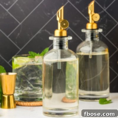 Bottles of homemade simple syrup on a table.