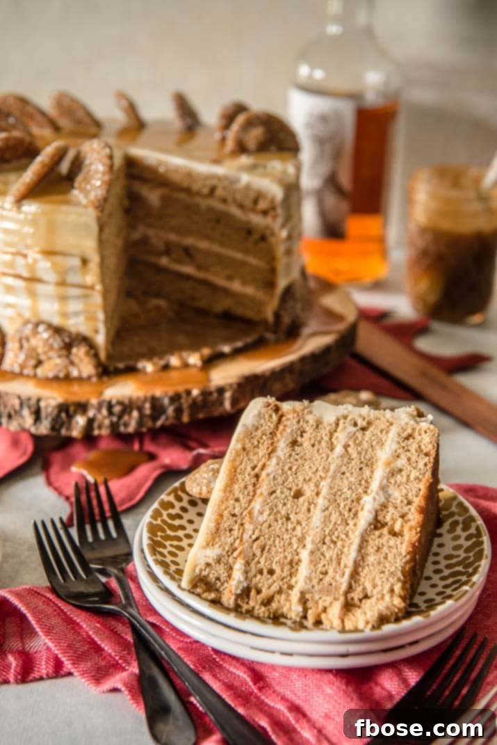 Spiced Bourbon Caramel Decadence 2 Close-up of a slice of Bourbon Caramel Spice Cake, showing multiple layers of spice cake, bourbon caramel cream cheese buttercream, and caramel drizzle.