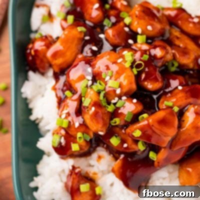 Effortless Bourbon Chicken 7 Bourbon Chicken plated on rice with green onion garnish