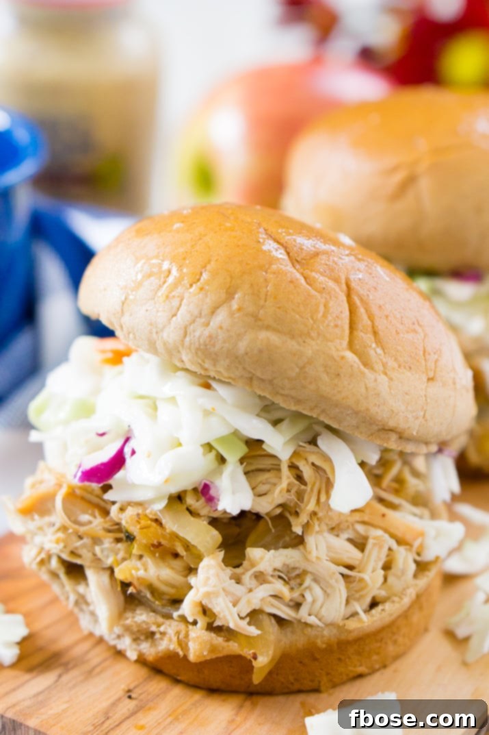 Weight Watchers Apple Cider Pulled Chicken served in a sandwich with slaw