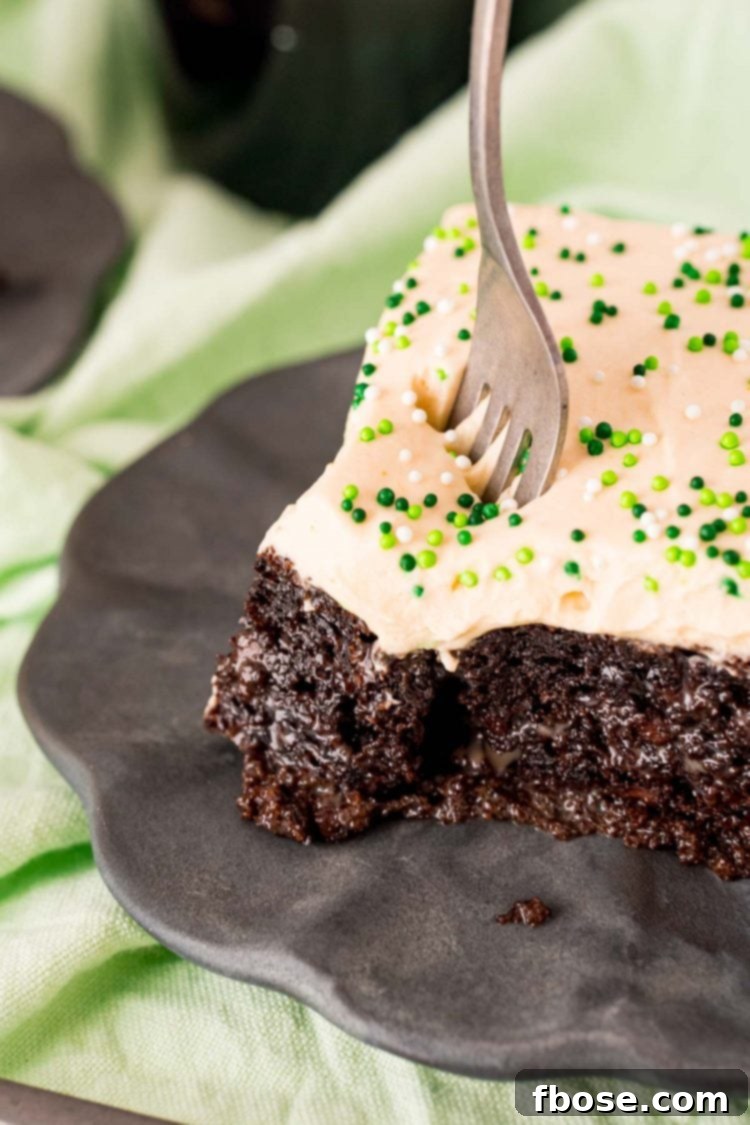 Close up photo of a fork taking a bite out of Bailey's cake, showing the moist interior.