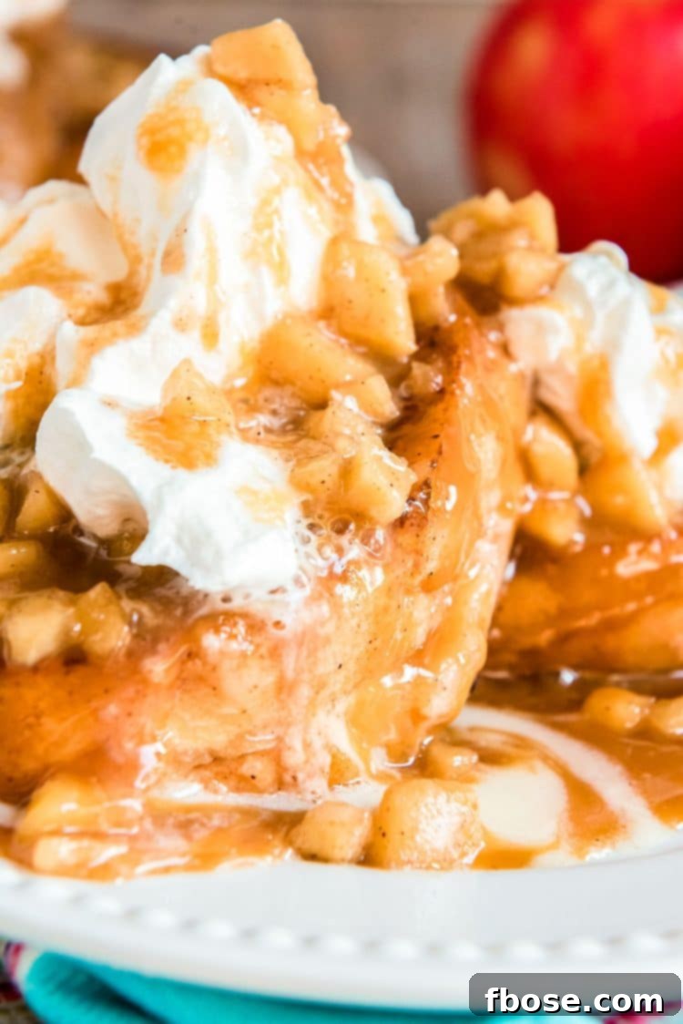 Close up photo of apple french toast on a white plate.
