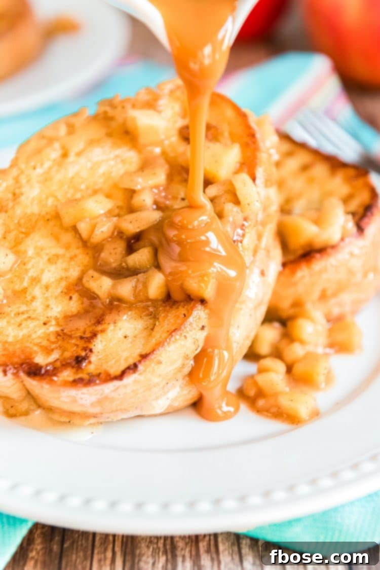 Caramel sauce being poured over french toast stuffed with apples